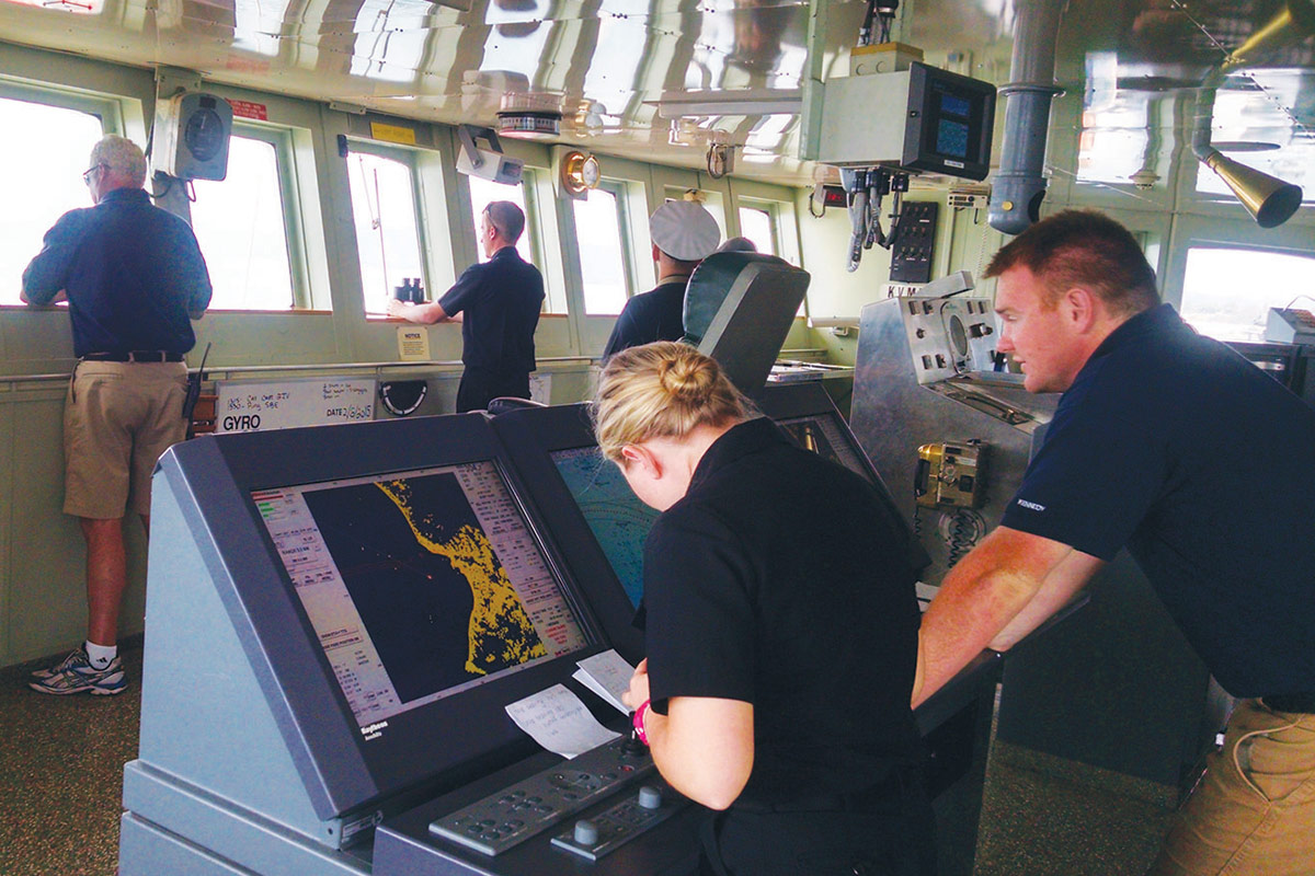 Cadets navigate on the ship’s bridge under the supervision of instructors and the professional crew.