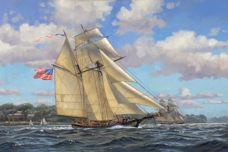 A maritime painting depicting the USS Spitfire, a two-masted schooner, sailing across choppy waters under a bright blue sky with fluffy clouds. The ship's sails are fully unfurled, catching the wind, and an American flag waves at the stern. The rigging and deck details are finely rendered, with crew members visible onboard. In the background, another sailing vessel follows at a distance, and a shoreline with buildings and trees lines the horizon. The artist's signature, 'Patrick O'Brien,' appears in the lower right corner.