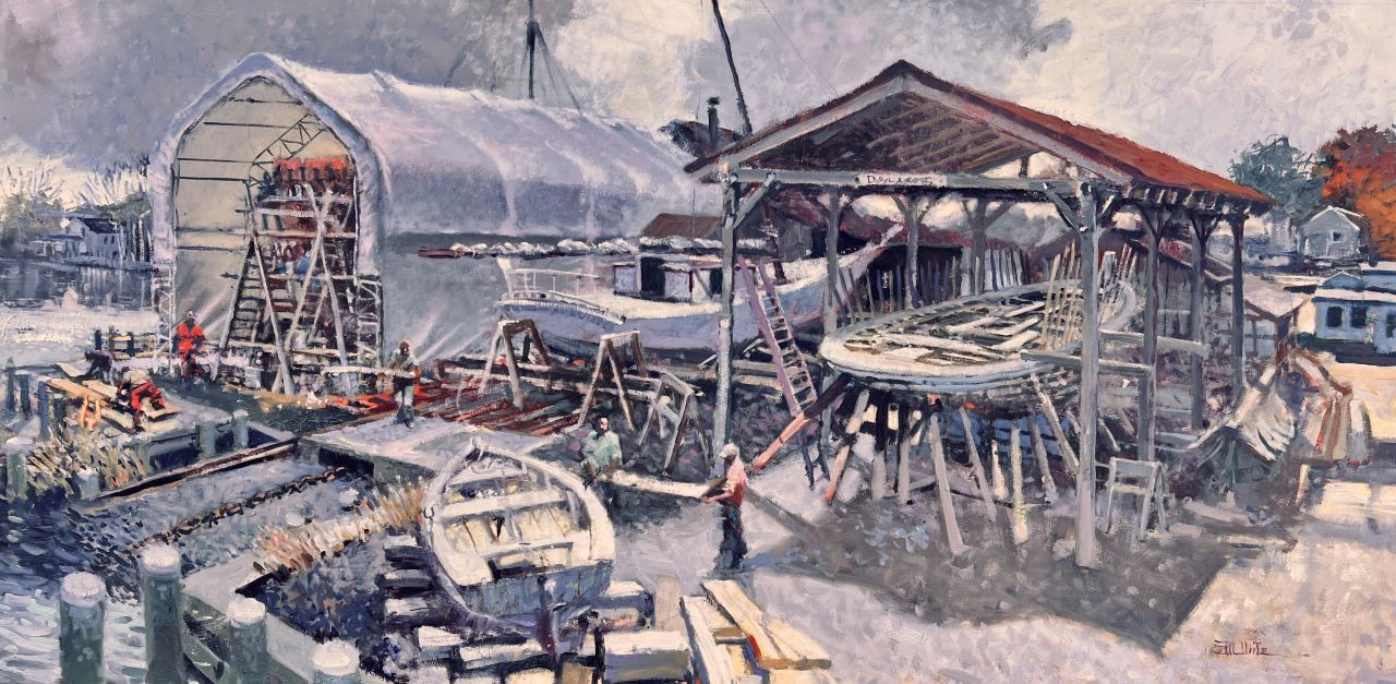 A view of the Chesapeake Bay Maritime Museum in St Michaels, Maryland with men working. On the far left under the canopy is The Dove, a reconstruction of a 17th century vessel that has since been put to sea. In the near right is the ship Delaware being rebuilt. 